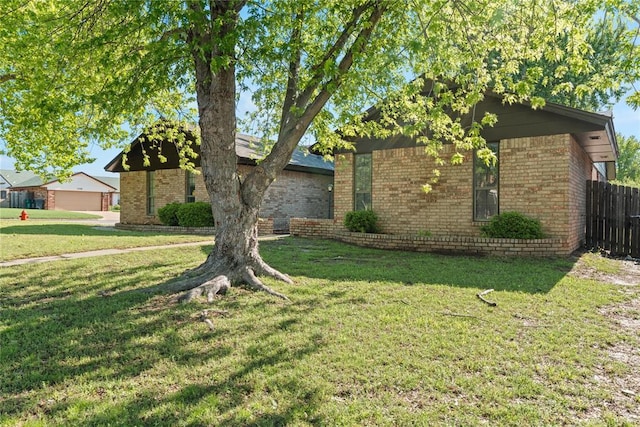 9800 Honeysuckle Rd, Oklahoma City, OK 73159 - view of front of property with fence, brick siding, and a front yard