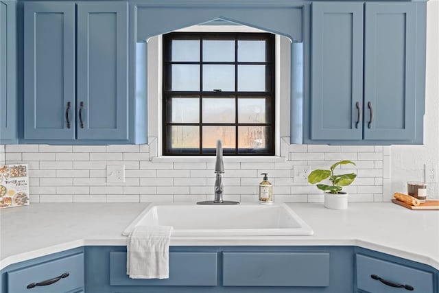 9800 Honeysuckle Rd, Oklahoma City, OK 73159 - kitchen featuring a sink, blue cabinets, a wealth of natural light, and light countertops