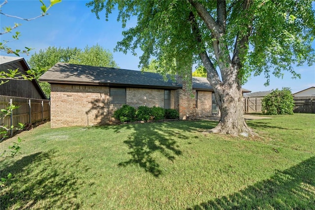 9800 Honeysuckle Rd, Oklahoma City, OK 73159 - exterior space featuring a yard, fence, and brick siding