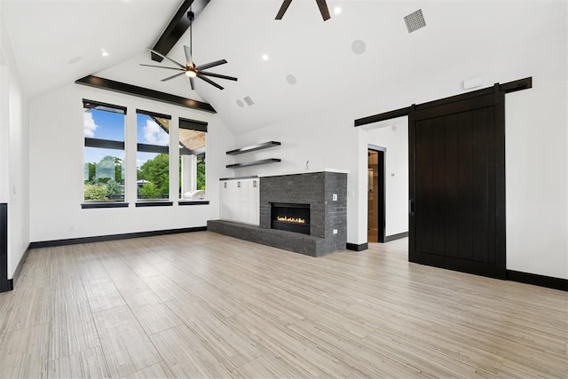 7217 Painted Sky Dr, Edmond, OK 73034 - unfurnished living room with ceiling fan, a barn door, and baseboards