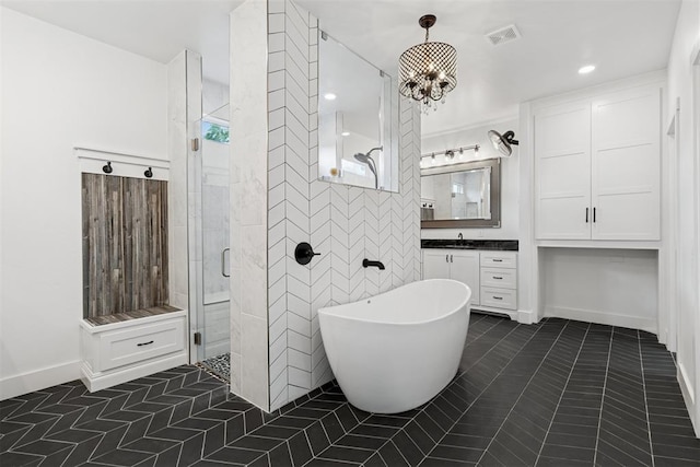 7217 Painted Sky Dr, Edmond, OK 73034 - full bathroom with a stall shower, tile patterned flooring, vanity, a freestanding bath, and a chandelier
