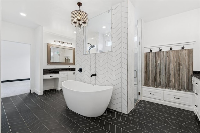 7217 Painted Sky Dr, Edmond, OK 73034 - full bathroom featuring tile patterned floors, vanity, a shower stall, a soaking tub, and a chandelier