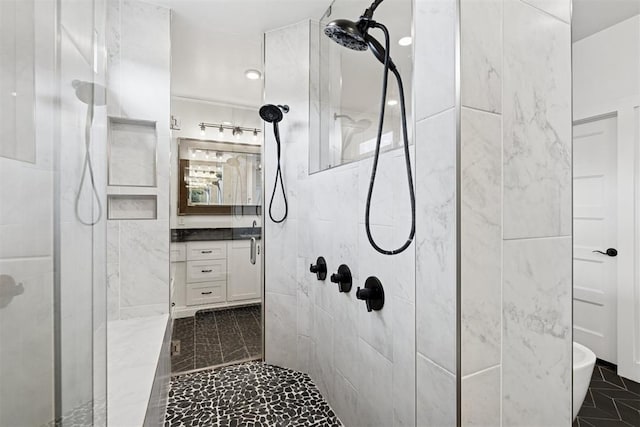 7217 Painted Sky Dr, Edmond, OK 73034 - bathroom featuring tiled shower, vanity, and marble finish floors