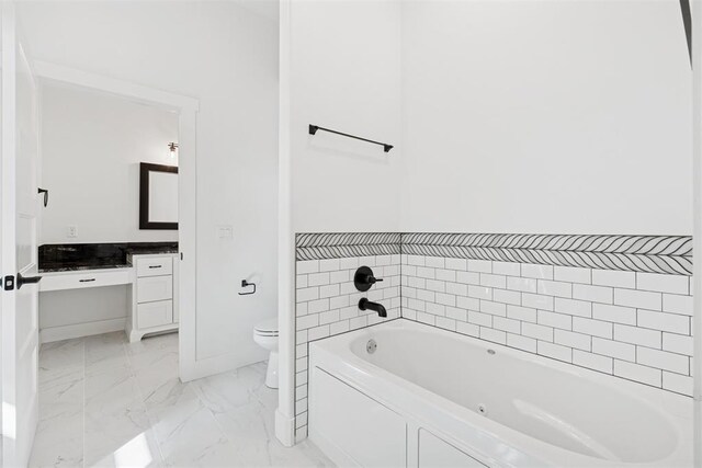 7217 Painted Sky Dr, Edmond, OK 73034 - bathroom featuring marble finish flooring, a bath, toilet, vanity, and baseboards