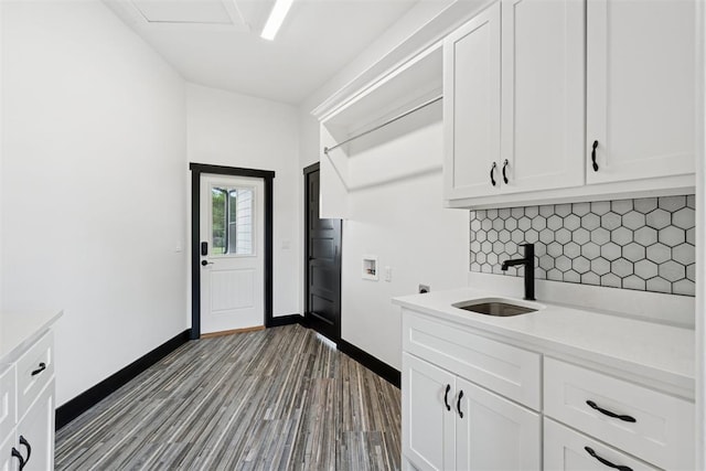 7217 Painted Sky Dr, Edmond, OK 73034 - clothes washing area with washer hookup, cabinet space, baseboards, dark wood finished floors, and electric dryer hookup