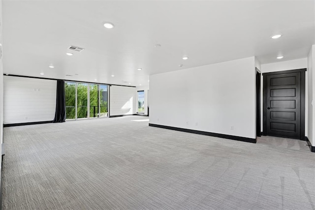 7217 Painted Sky Dr, Edmond, OK 73034 - unfurnished living room featuring light carpet, recessed lighting, and baseboards