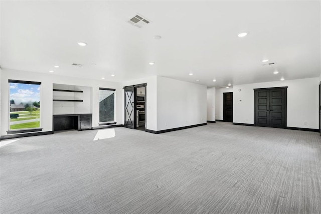 7217 Painted Sky Dr, Edmond, OK 73034 - unfurnished living room featuring light colored carpet, recessed lighting, and baseboards