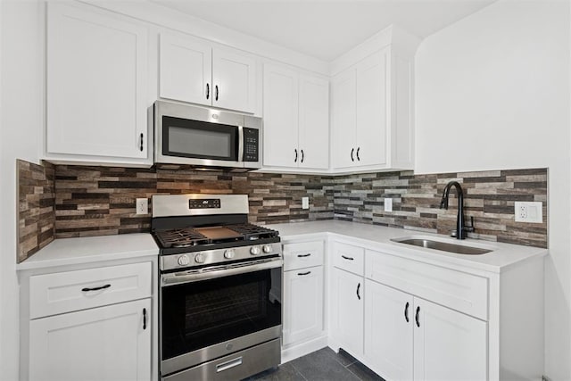 7217 Painted Sky Dr, Edmond, OK 73034 - kitchen with appliances with stainless steel finishes, a sink, light countertops, and white cabinetry