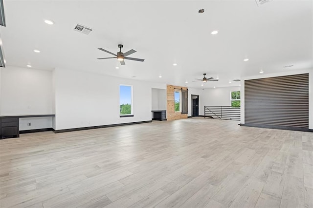 7217 Painted Sky Dr, Edmond, OK 73034 - unfurnished living room featuring ceiling fan, healthy amount of natural light, recessed lighting, and light wood-type flooring