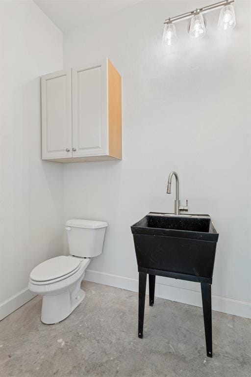 7217 Painted Sky Dr, Edmond, OK 73034 - half bathroom featuring baseboards, toilet, and unfinished concrete flooring