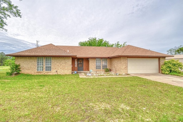ranch-style home featuring concrete driveway, a front lawn, brick siding, and a garage