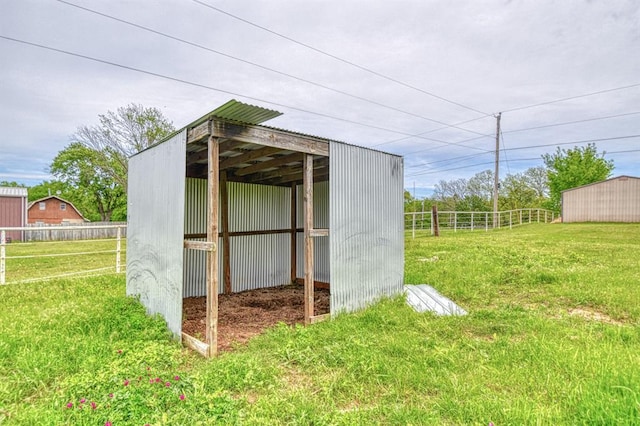 view of pole building featuring a yard and fence