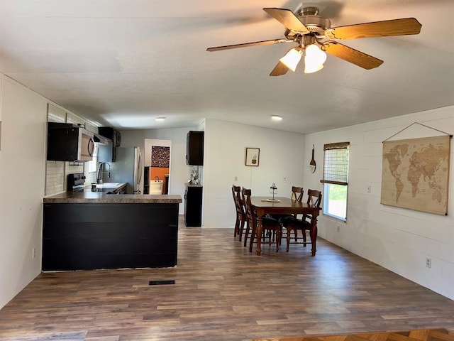 559 Poppy Rd, Broken Bow, OK 74728 - dining area featuring lofted ceiling, ceiling fan, visible vents, and dark wood-type flooring