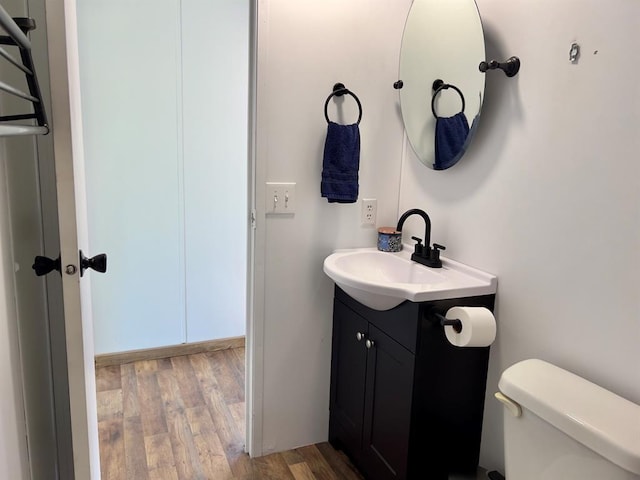 559 Poppy Rd, Broken Bow, OK 74728 - half bath featuring vanity, toilet, and wood finished floors