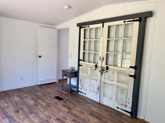 559 Poppy Rd, Broken Bow, OK 74728 - entryway with vaulted ceiling, visible vents, and wood finished floors