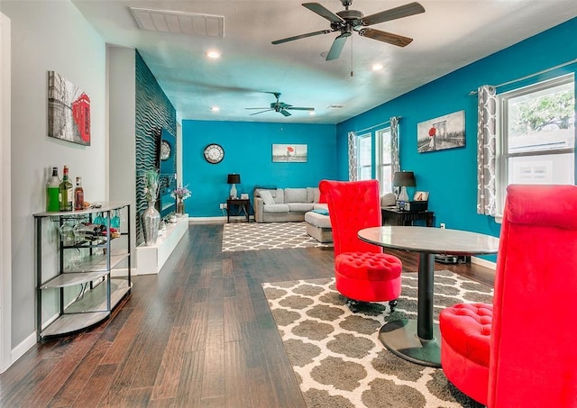 2107 NW 20th St, Oklahoma City, OK 73107 - living room featuring wood finished floors, a ceiling fan, recessed lighting, baseboards, and an accent wall