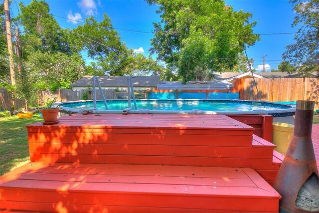 2107 NW 20th St, Oklahoma City, OK 73107 - view of swimming pool featuring a fenced backyard and a wooden deck