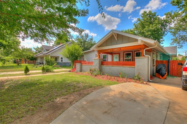 2107 NW 20th St, Oklahoma City, OK 73107 - view of front facade with board and batten siding and a porch