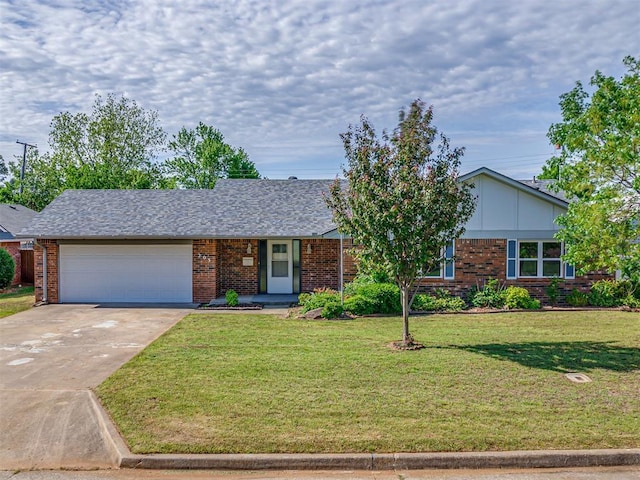 view of front of property featuring brick siding, an attached garage, driveway, and a front yard