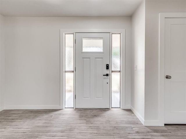 entryway with light wood-style floors and baseboards