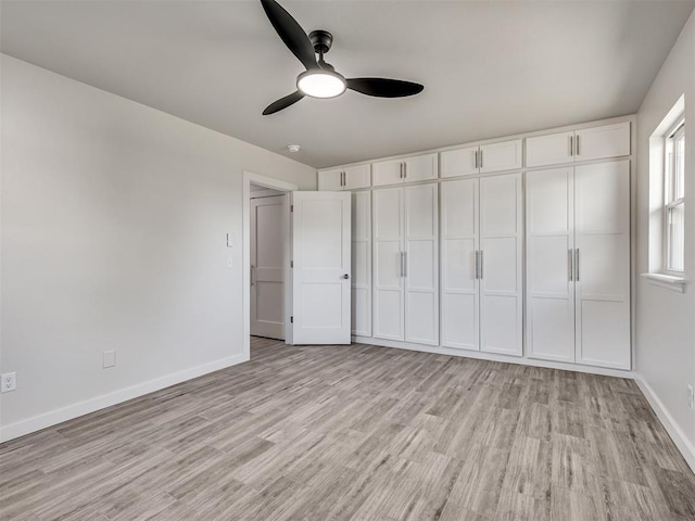 unfurnished bedroom with light wood-type flooring, baseboards, and ceiling fan