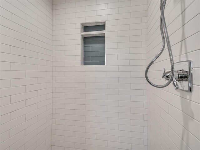 full bath featuring a tile shower