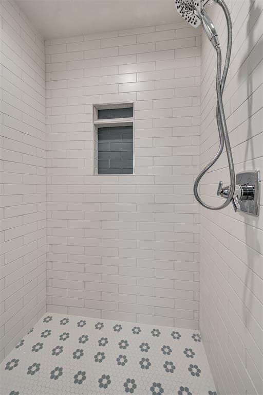 full bath with a tile shower