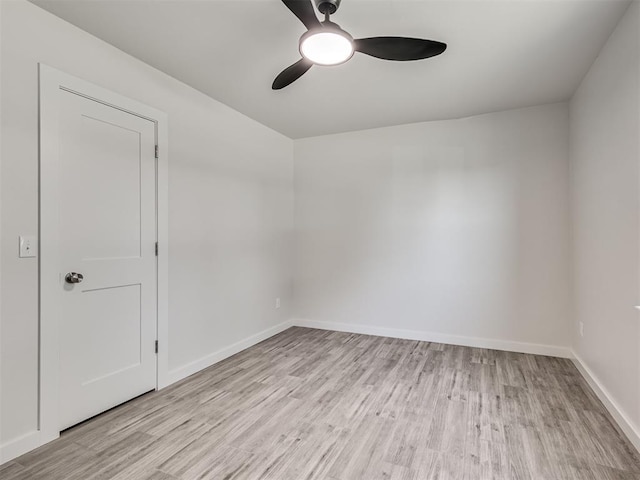unfurnished room featuring ceiling fan, wood finished floors, and baseboards