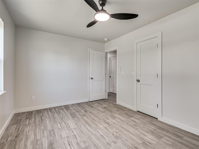 unfurnished bedroom with wood finished floors, baseboards, and a ceiling fan