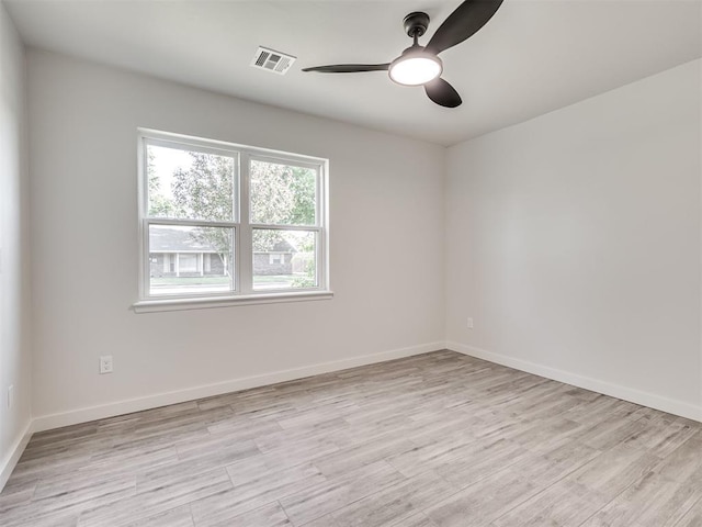 unfurnished room featuring ceiling fan, light wood-type flooring, and baseboards