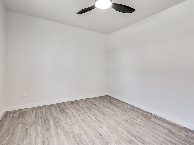 empty room featuring wood finished floors, ceiling fan, and baseboards