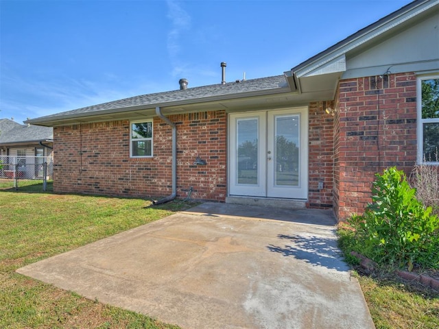 rear view of property with brick siding, french doors, and a patio area