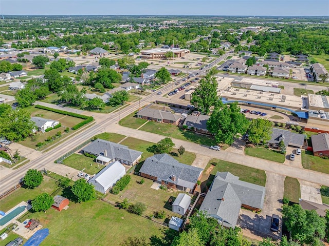 aerial view of property and surrounding area featuring nearby suburban area