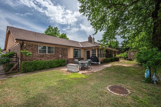11125 NW 116th St, Yukon, OK 73099 - rear view of property featuring a patio area, a chimney, brick siding, and a gate
