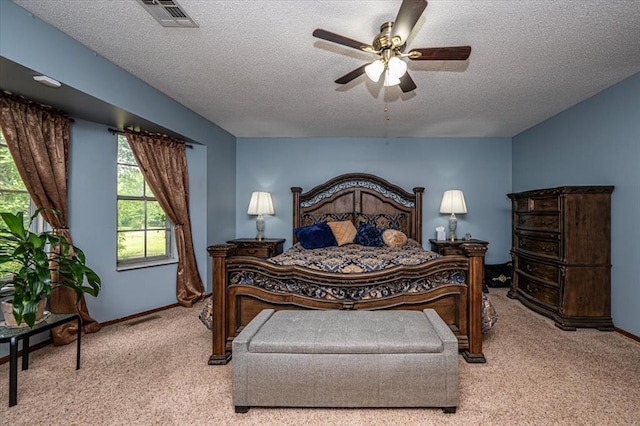 11125 NW 116th St, Yukon, OK 73099 - bedroom with carpet flooring, a textured ceiling, baseboards, and a ceiling fan