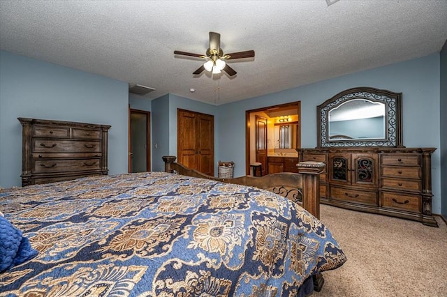 11125 NW 116th St, Yukon, OK 73099 - carpeted bedroom with a ceiling fan, a textured ceiling, and ensuite bathroom