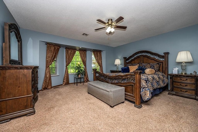 11125 NW 116th St, Yukon, OK 73099 - carpeted bedroom featuring a textured ceiling and a ceiling fan