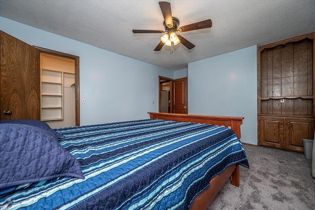11125 NW 116th St, Yukon, OK 73099 - carpeted bedroom with a textured ceiling and a ceiling fan