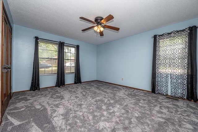 11125 NW 116th St, Yukon, OK 73099 - carpeted spare room with a ceiling fan, a textured ceiling, and baseboards