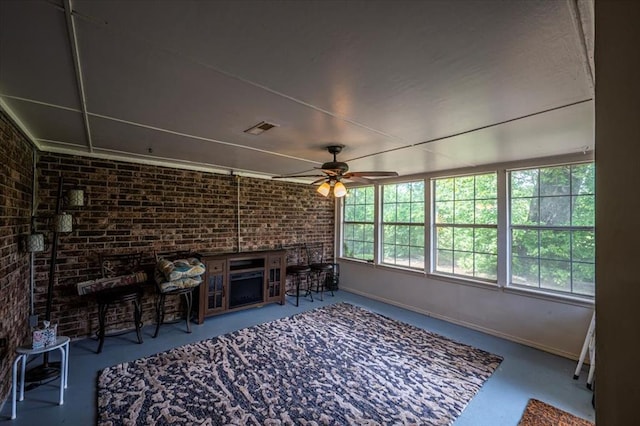 11125 NW 116th St, Yukon, OK 73099 - unfurnished living room with brick wall, ceiling fan, and baseboards