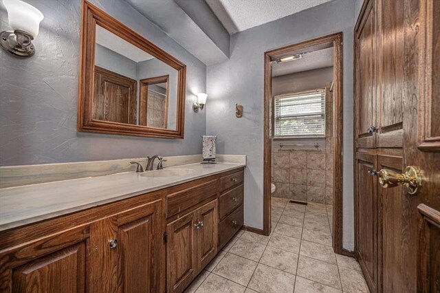 11125 NW 116th St, Yukon, OK 73099 - bathroom featuring toilet, vanity, tile patterned flooring, a textured ceiling, and baseboards