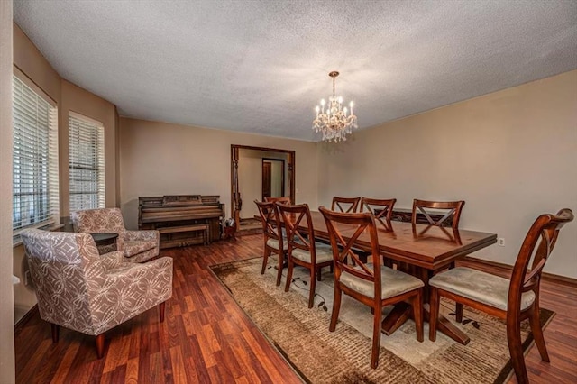 11125 NW 116th St, Yukon, OK 73099 - dining area featuring a textured ceiling, a chandelier, and dark wood-style floors