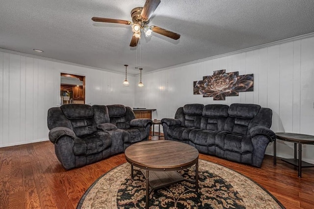 11125 NW 116th St, Yukon, OK 73099 - living room featuring ceiling fan, wood finished floors, a textured ceiling, and ornamental molding