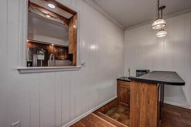 11125 NW 116th St, Yukon, OK 73099 - bar with fridge with ice dispenser, ornamental molding, dark wood-style flooring, baseboards, and a textured ceiling