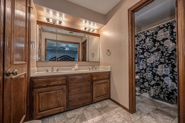 11125 NW 116th St, Yukon, OK 73099 - full bathroom with double vanity, baseboards, and a shower with curtain