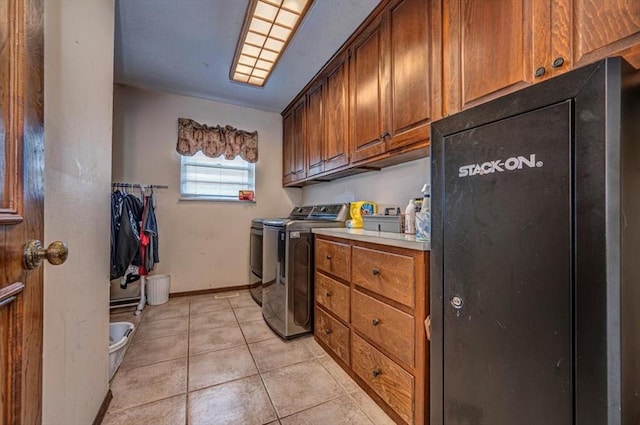 11125 NW 116th St, Yukon, OK 73099 - laundry room featuring cabinet space, washer and clothes dryer, light tile patterned flooring, and baseboards