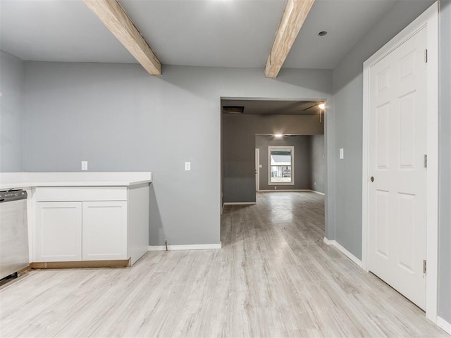 interior space featuring light wood-type flooring, baseboards, and beamed ceiling