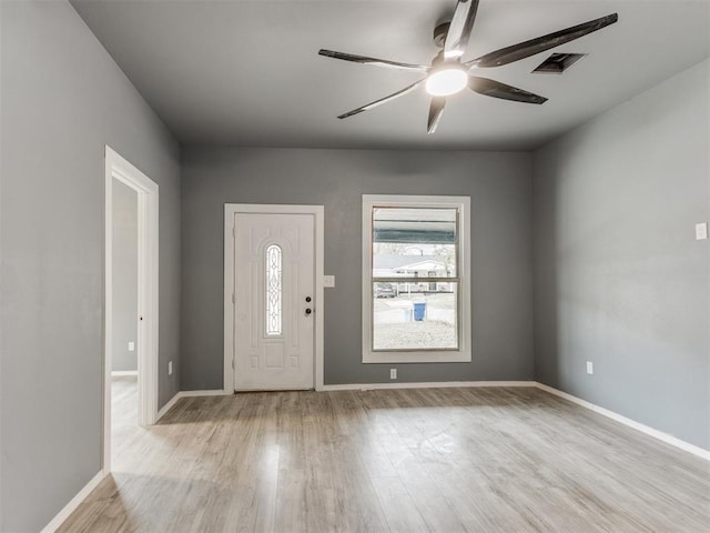 entryway featuring ceiling fan, baseboards, and light wood finished floors