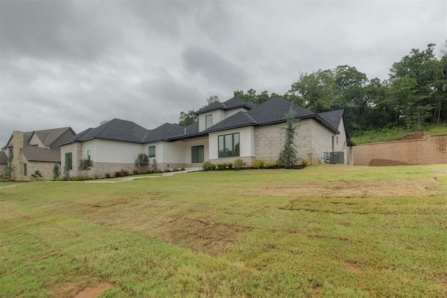6516 NE 97th St, Oklahoma City, OK 73151 - view of front of house with stone siding, a front lawn, and stucco siding