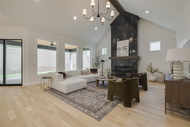 6516 NE 97th St, Oklahoma City, OK 73151 - living area featuring high vaulted ceiling, light wood-style flooring, a tile fireplace, beam ceiling, and a chandelier